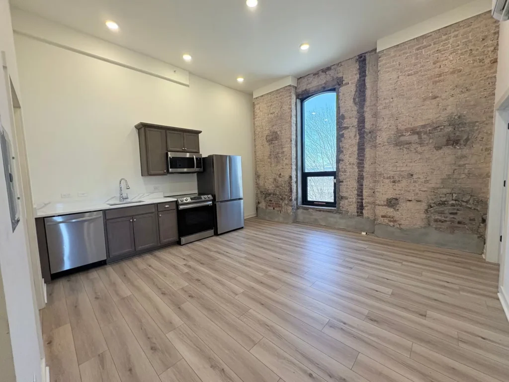 grandview hotel interior kitchen with stainless appliances and exposed brick wall on exterior window