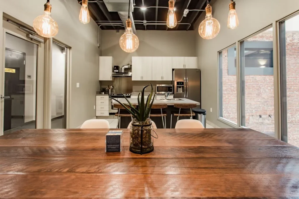 Interior shared kitchen with stainless appliances and island with sink