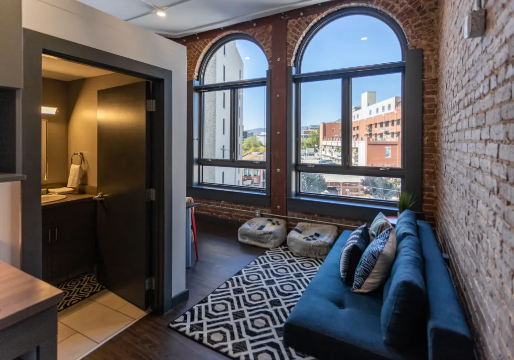 patten parkway interior studio with large windows and view of downtown