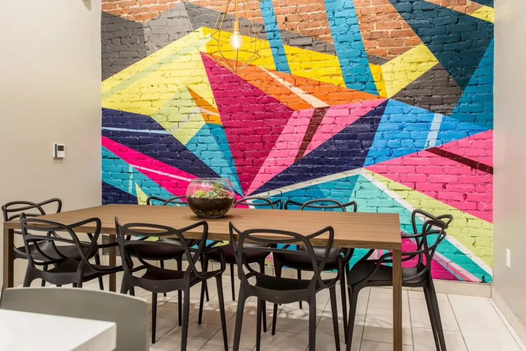 shared interior kitchen with large table and wall mural