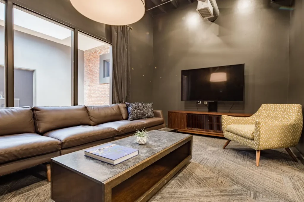 patten parkway interior shared common area living room with couch, tv, coffee table, chair