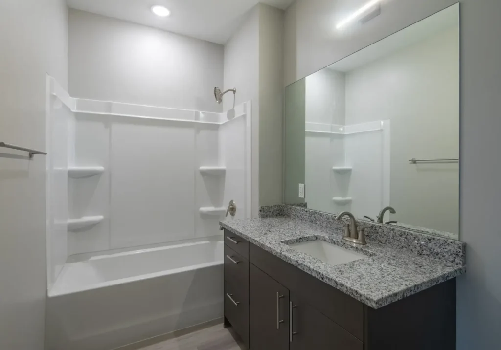 interior bathroom photo mirror, shower with tub, vanity with sink