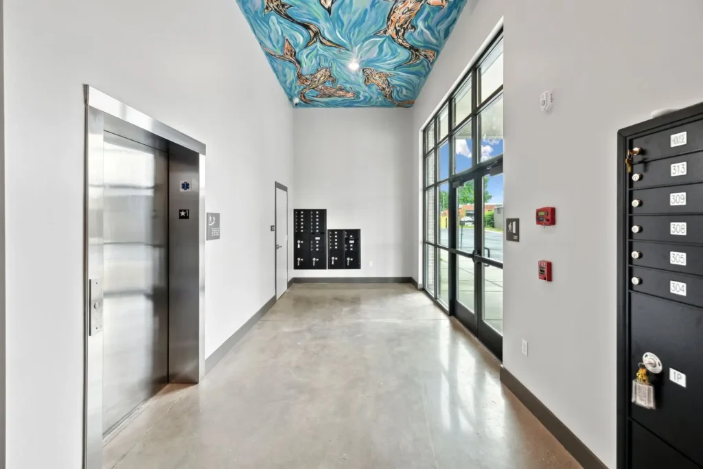 Interior entrance lobby with mailboxes, elevator, and exterior front doors